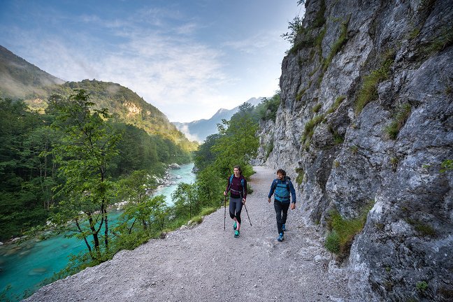 Hikers walk along the Juliana Trail along the emerald Soča River