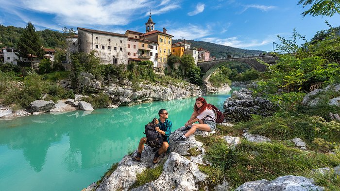 The couple enjoys the Soča River, which flows under the Kanal Bridge.