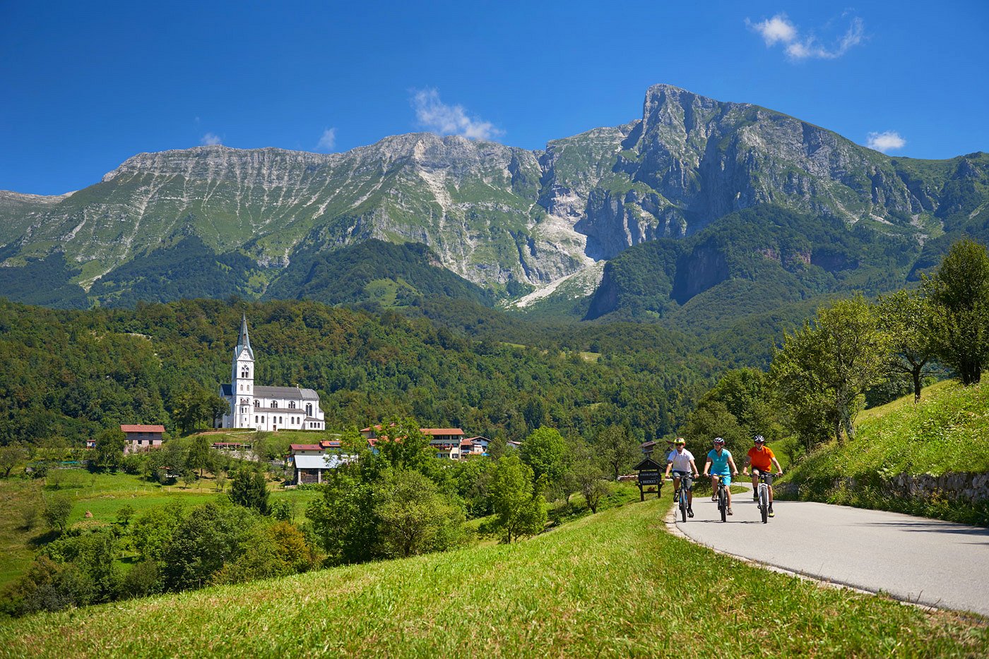 Radfahrer genießen die Aussicht in der Nähe des Dorfes Drežnica unter dem Berg Krn